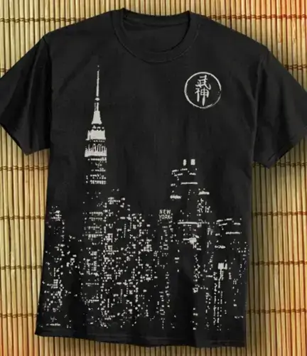 A photo of an all over front print of a cityscape running off the bottom of the shirt.