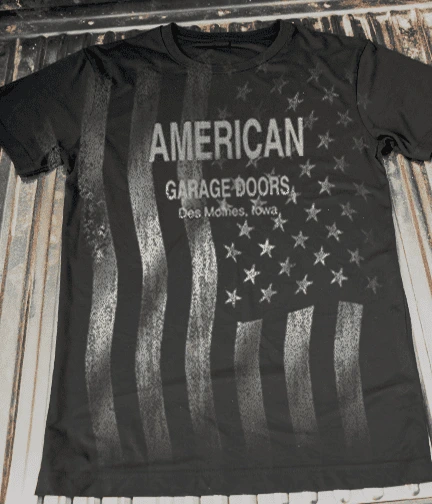A photo of an all over print on the front of a t-shirt with an american flag. 