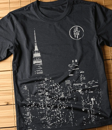 A photo of an all over front print of a cityscape running off the bottom of the shirt.