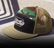 a photo of a 7panel black, camo and khaki trucker hat with white dtf on the front