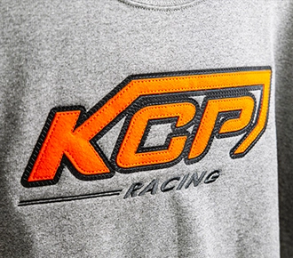 KCP racing design in orange and black applique on a grey hooded sweatshirt