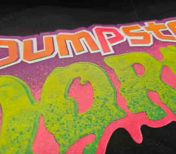 person wearing a navy crewneck sweatshirt with a custom screen print on it.