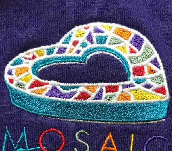 Colorful embroidered mosaic-style logo with raised stitching detail on a purple garment.