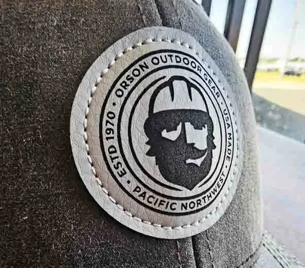 Closeup of round leather patch on gray custom trucker hat