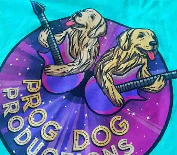 photo of a screen print of 2 dogs playing the guitar on a teal background. 