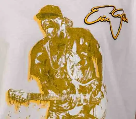 Graphic t-shirt featuring illustrated guitarist performance in gold print on white background