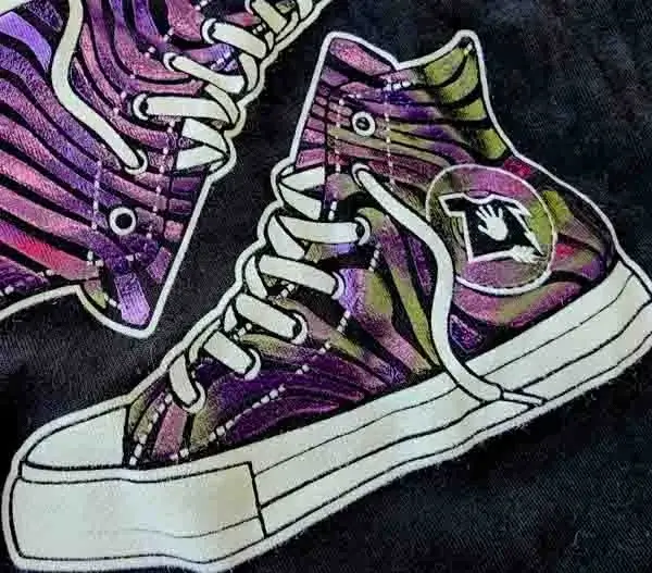 purple foil patterned high top sneaker graphic on black t-shirt