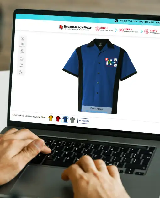 a photo of a person on a laptop creating a custom design on a sea colored bowling shirt