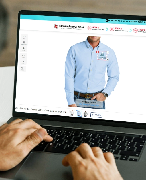 a photo of a person on a laptop designing a oxford in the BrokenArrowWear online design studio