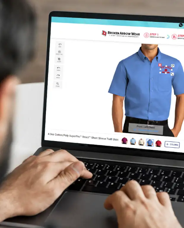 a photo of a person on a laptop creating a custom design on a blue color easy care shirt