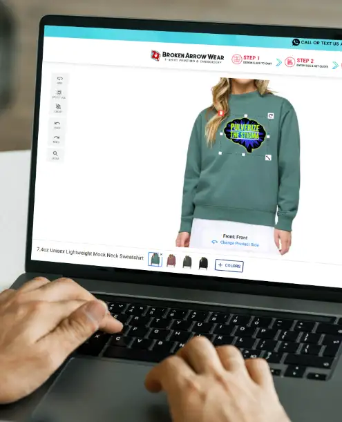 a photo of a person on a laptop designing a mock neck sweatshirt in the BrokenArrowWear online design studio