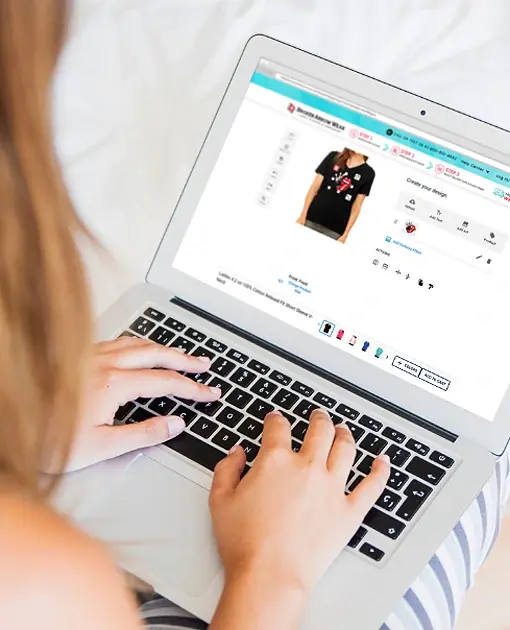 a photo of a person on a laptop designing a women's v-neck t-shirt in the BrokenArrowWear online design studio