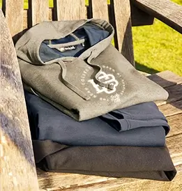 a stack of hooded sweatshirts with a white custom print on the front