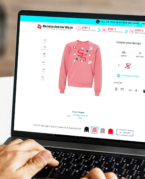 a person on the computer creating a youth crewneck sweatshirt in the online design tool