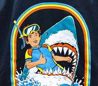 Screen printed navy blue t-shirt featuring a retro graphic of a scuba diver inside a shark's mouth with a colorful rainbow arch.