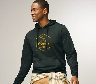 photo of a guy wearing a navy blue french terry hoodie with a printed logo