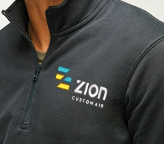 person wearing a lavander crewneck sweatshirt with a embroidered tiger