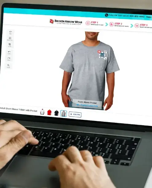 Hands on a laptop designing a pocket tee in the Broken Arrow Wear online designer