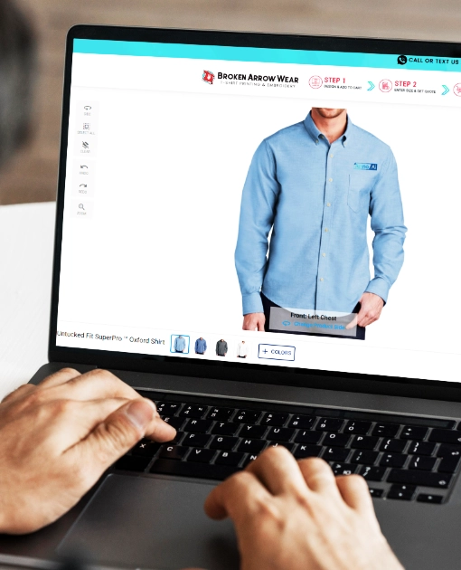 Hands on a laptop designing a oxfords shirt in the Broken Arrow Wear online designer