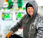 man wearing a carhartt coat with hood up