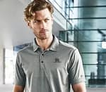 man wearing a grey polo with embroidery on the left chest