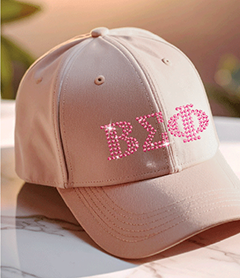 Greek letter sorority logo in pink rhinestones on a tan baseball cap.