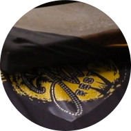 photo of a black t-shirt with a rhinestone transfer on top of it ready to be heat pressed