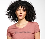 a woman wearing a pick v-neck t-shirt with a rhinestone design on