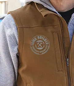 Workwear canvas vest in duck brown featuring a custom reflective circular chest logo.