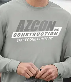 Heather grey long-sleeve work shirt with a bold AZCON Construction logo and safety slogan.
