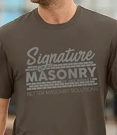 Custom Signature Masonry logo printed on a dark olive green crewneck t-shirt for trade branding.