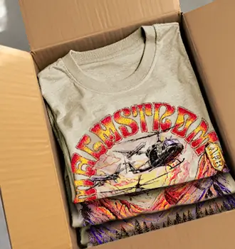 Folded custom Malmstrom AFB t-shirt in a box featuring a colorful helicopter and mountain design